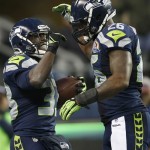 Seattle Seahawks running back Leon Washington (33) celebrates with fullback Michael Robinson (26) after scoring on a 3-yard touchdown run against the Arizona Cardinals during the fourth quarter of an NFL football game in Seattle, Sunday, Dec. 9, 2012. The Seahawks won 58-0. (AP Photo/John Froschauer)