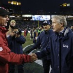 Arizona Cardinals head coach Ken Whisenhunt, left, shakes hands with Seattle Seahawks head coach Pete Carroll after an NFL football game in Seattle, Sunday, Dec. 9, 2012. The Seahawks won 58-0. (AP Photo/John Froschauer)