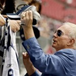 Dallas Cowboys owner Jerry Jones signs autographs prior to the Cowboys' preseason NFL football game against the Arizona Cardinals on Saturday, Aug. 17, 2013, in Glendale, Ariz. (AP Photo/Ross D. Franklin)