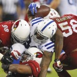 Indianapolis Colts running back Trent Richardson, center, is tackled by Arizona Cardinals defensive end Frostee Rucker (98), Karlos Dansby (56) during the second half of an NFL football game, Sunday, Nov. 24, 2013, in Glendale, Ariz. The Cardinals won 40-11. (AP Photo/Rick Scuteri)