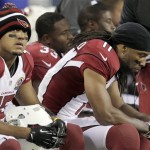 Arizona Cardinals wide receiver Larry Fitzgerald (11) and wide receiver Michael Floyd (15) sit on the bench during the fourth quarter of an NFL football game against the Seattle Seahawks in Seattle, Sunday, Dec. 9, 2012. The Seahawks won 58-0. (AP Photo/Stephen Brashear)
