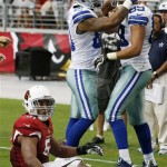 Dallas Cowboys' Gavin Escobar (89) celebrates his touchdown with teammate Dante Rosario as Arizona Cardinals' Kevin Minter, left, sits on the ground in the second half of an NFL football game on Saturday, Aug. 17, 2013, in Glendale, Ariz. The Cardinals defeated the Cowboys 12-7. (AP Photo/Ross D. Franklin)