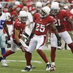 Arizona Cardinals' Jerraud Powers, decond from right, celebrates his interception with teammates Tyrann Mathieu (32) and Patrick Peterson (21) as Dallas Cowboys' Lance Dunbar, left, looks on in the first half during a preseason NFL football game on Saturday, Aug. 17, 2013, in Glendale, Ariz. (AP Photo/Ross D. Franklin)