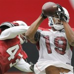 Arizona Cardinals' Nicholas Edwards (19) makes the catch as teammate Ronnie Yell (43) defends during an NFL football training camp, Friday, Aug. 2, 2013, in Glendale, Ariz. (AP Photo/Matt York)