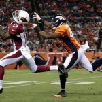 Arizona Cardinals wide receiver Jaron Brown (13) pulls in a 55-yard touchdown pass as Denver Broncos defensive back Aaron Hester (40) tries to defend during the third quarter of a preseason NFL football game, Thursday, Aug. 29, 2013, in Denver. (AP Photo/Joe Mahoney)