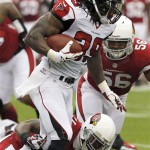 Atlanta Falcons running back Steven Jackson (39) escapes the reach of Arizona Cardinals cornerback Patrick Peterson, bottom, during the first half of an NFL football game Sunday, Oct. 27, 2013, in Glendale, Ariz. (AP Photo/Ross D. Franklin)