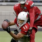 Arizona Cardinals' Larry Fitzgerald (11) beats Patrick Peterson (21) for a pass during NFL football training camp practice at University of Phoenix Stadium on Tuesday, July 30, 2013, in Glendale, Ariz. (AP Photo/Ross D. Franklin)