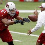 Arizona Cardinals' Kevin Minter (51) tips the ball away from a coach during linebacker drills at NFL football training camp practice on Monday, Aug. 5, 2013, in Glendale, Ariz. (AP Photo/Ross D. Franklin)