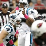 Carolina Panthers quarterback Cam Newton (1) looks to throw under pressure from Arizona Cardinals nose tackle Alameda Ta'amu, right, during the first half of a NFL football game, Sunday, Oct. 6, 2013, in Glendale, Ariz. (AP Photo/Matt York)