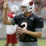 Arizona Cardinals' Carson Palmer gives signals during passing drills at NFL football training camp practice on Monday, Aug. 5, 2013, in Glendale, Ariz. (AP Photo/Ross D. Franklin)