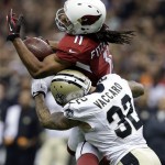 Arizona Cardinals wide receiver Larry Fitzgerald (11) pulls in a pass over New Orleans Saints strong safety Kenny Vaccaro (32) in the first half of an NFL football game in New Orleans, Sunday, Sept. 22, 2013. (AP Photo/Gerald Herbert)