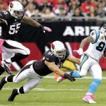 Carolina Panthers wide receiver Steve Smith (89) escapes the reach of Arizona Cardinals defensive end Matt Shaughnessy (91) and John Abraham during the first half of a NFL football game, Sunday, Oct. 6, 2013, in Glendale, Ariz. (AP Photo/Rick Scuteri)