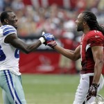 Arizona Cardinals wide receiver Larry Fitzgerald (11) and Dallas Cowboys wide receiver Dez Bryant (88) greet each other during a time out during the first half of a preseason NFL football game on Saturday, Aug. 17, 2013, in Glendale, Ariz. (AP Photo/Rick Scuteri)