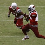 Arizona Cardinals' Patrick Peterson, right, makes a catch in front of Jonathon Amaya, as Peterson played on the offensive side of the ball for a few series during NFL football training camp at University of Phoenix Stadium on Tuesday, July 30, 2013, in Glendale, Ariz. (AP Photo/Ross D. Franklin)