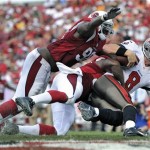 Tampa Bay Buccaneers quarterback Mike Glennon (8) is sacked by Arizona Cardinals Dontay Moch (50) and Frostee Rucker (98) during the fourth quarter of an NFL football game on Sunday, Sept. 29, 2013, in Tampa, Fla. (AP Photo/Brian Blanco)