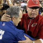 Arizona Cardinals head coach Bruce Arians, right, and Indianapolis Colts head coach Chuck Pagano embrace after an NFL football game Sunday, Nov. 24, 2013, in Glendale, Ariz. The Cardinals defeated the Colts 40-11. (AP Photo/Ross D. Franklin)