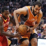 Phoenix Suns center Hamed Haddadi, right of Iran, is fouled by Houston Rockets guard Patrick Beverley, left, during the second half of an NBA basketball game Saturday, March 9, 2013, in Phoenix. The Suns won 107-105. (AP Photo/Paul Connors)
