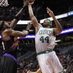 Boston Celtics center Chris Wilcox, right, soars to the basket against Phoenix center Jermaine O'Neal, left, in the first half of an NBA basketball game Friday, Feb. 22, 2013, in Phoenix. The Celtics won 113-88.(AP Photo/Paul Connors)