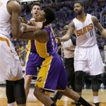  Los Angeles Lakers' Nick Young, second from right, gets into a scuffle with Phoenix Suns' Marcus Morris, left, and other Suns players, as Suns' Markieff Morris (11) and Lakers' Ryan Kelly, second from left, arrive for the fracas during the first half of an NBA basketball game Wednesday, Jan. 15, 2014, in Phoenix. Young and Suns' Alex Len were both ejected from the game. (AP Photo/Ross D. Franklin)