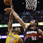 Los Angeles Lakers' Metta World Peace (15) gets fouled as he goes up for a shot against Phoenix Suns' Hamed Haddadi (98), of Iran, in the first half of an NBA basketball game, Monday, March 18, 2013, in Phoenix. (AP Photo/Ross D. Franklin)