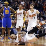  Phoenix Suns' P.J. Tucker, front, falls to the court after sinking a jump shot while being fouled by Golden State Warriors' Jermaine O'Neal (7) as Suns' Goran Dragic (1), of Slovenia, and Channing Frye (8) run over to Tucker during the first half of an NBA basketball game Saturday, Feb. 8, 2014, in Phoenix. (AP Photo/Ross D. Franklin)