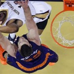 New Orleans Pelicans shooting guard Eric Gordon (10) goes to the basket against Phoenix Suns power forward Miles Plumlee (22) in the first half of an NBA basketball game in New Orleans, Tuesday, Nov. 5, 2013. (AP Photo/Gerald Herbert)