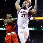Milwaukee Bucks' Brandon Jennings (3) collides with Phoenix Suns' P.J. Tucker (17) as he drives to the basket during the first half of an NBA basketball game, Thursday, Jan. 17, 2013, in Phoenix. (AP Photo/Ross D. Franklin)