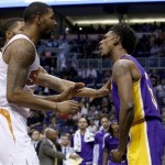  Los Angeles Lakers' Nick Young, right, has words with Phoenix Suns' Marcus Morris and Markieff Morris, rear, during the first half of an NBA basketball game Wednesday, Jan. 15, 2014, in Phoenix. Young was ejected from the game along with Suns' Alex Len. (AP Photo/Ross D. Franklin)