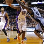 Memphis Grizzlies' Tony Allen (9) and Phoenix Suns' Jermaine O'Neal chase down a loose ball during the first half of an NBA basketball game, Sunday, Jan. 6, 2013, in Phoenix. (AP Photo/Matt York)