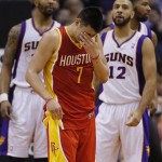 Houston Rockets' Jeremy Lin (7) rubs his eye as Phoenix Suns' Markieff Morris and Kendall Marshall (12) look on during the second half of an NBA basketball game, Monday, April 15, 2013, in Phoenix. (AP Photo/Matt York)
