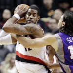 Phoenix Suns forward Luis Scola, right, of Argentina, reaches in on Portland Trail Blazers forward LaMarcus Aldridge during the first half of an NBA basketball game in Portland, Ore., Tuesday, Feb. 19, 2013. (AP Photo/Don Ryan)