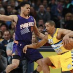 Denver Nuggets guard Andre Miller, right, works the ball inside as Phoenix Suns guard Gerald Green covers in the first quarter of an NBA basketball game in Denver on Friday, Dec. 20, 2013. (AP Photo/David Zalubowski)