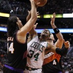 Phoenix Suns forward Luis Scola, left, of Argentina, battles Boston Celtics forward Paul Pierce, center, and Suns center Marcin Gortat, right, of Poland, for the loose ball in the second half of an NBA basketball game, Friday, Feb. 22, 2013, in Phoenix. The Celtics won 113-88. (AP Photo/Paul Connors)