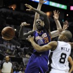 Phoenix Suns' Archie Goodwin, left, loses the ball as he is defended by San Antonio Spurs' Patty Mills, of Australia, during the second half of an NBA preseason basketball game, Sunday, Oct. 13, 2013, in San Antonio. Phoenix won 106-99. (AP Photo/Darren Abate)