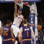 New York Knicks' Kenyon Martin (3) dunks the ball in front of Phoenix Suns' Goran Dragic (1) and Marcus Morris (15) during the overtime period of an NBA basketball game Monday, Jan. 13, 2014, in New York. The Knicks won the game 98-96. (AP Photo/Frank Franklin II)