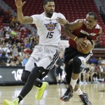 Miami Heat's James Nunnally, right, drives to the basket against Phoenix Suns' Marcus Morris in the fourth quarter of an NBA Summer League basketball game, Sunday, July 21, 2013, in Las Vegas. (AP Photo/Julie Jacobson)