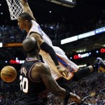 Oklahoma City Thunder's Russell Westbrook, right, dunks over Phoenix Suns' Jermaine O'Neal (20) during the first half in an NBA basketball game, Sunday, Feb. 10, 2013, in Phoenix. (AP Photo/Ross D. Franklin)

