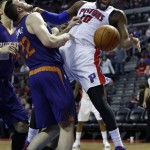 Detroit Pistons center Greg Monroe (10) looses the ball after colliding with Phoenix Suns center Miles Plumlee (22) during the second half of an NBA basketball game, Saturday, Jan. 11, 2014, in Auburn Hills, Mich. (AP Photo/Duane Burleson)
