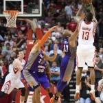 Houston Rockets guard James Harden (13) takes a 3-pointer over Phoenix Suns guard P.J. Tucker (17) in the final seconds of an NBA basketball game Tuesday, April 9, 2013, in Houston. Suns' Jermaine O'Neal was called for goaltending, and the Rockets won 101-98. (AP Photo/Houston Chronicle, Smiley N. Pool)