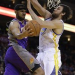 Phoenix Suns' Jared Dudley, left, looks to pass away from Golden State Warriors' Andrew Bogut in the first half of an NBA basketball game Saturday, Feb. 2, 2013, in Oakland, Calif. (AP Photo/Ben Margot)
