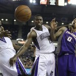 Phoenix Suns forward Michael Beasley right, battles for the ball with Sacramento Kings' DeMarcus Cousins, left, and Tyreke Evans, during the third quarter of an NBA basketball game in Sacramento, Calif., Wednesday, Jan. 23, 2013. The Suns won 106-96.(AP Photo/Rich Pedroncelli)