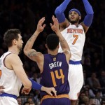 New York Knicks' Carmelo Anthony (7) shoots a 3-point basket over Phoenix Suns' Gerald Green (14) during the first half of an NBA basketball game, Monday, Jan. 13, 2014, in New York. (AP Photo/Frank Franklin II)