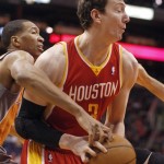 Houston Rockets center Omer Asik, right, controls a rebound as Phoenix Suns forward Wesley Johnson, left, reaches in to try and make a steal during the first half of an NBA basketball game Saturday, March 9, 2013, in Phoenix.(AP Photo/Paul Connors)
