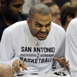San Antonio Spurs' Tony Parker, of France, makes faces on the bench during the second half of an NBA preseason basketball game against the Phoenix Suns, Sunday, Oct. 13, 2013, in San Antonio. Phoenix won 106-99. (AP Photo/Darren Abate)