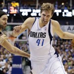 Dallas Mavericks' Dirk Nowitzki (41), of Germany, drives by Phoenix Suns' Luis Scola, left, of Argentina, during the second half of an NBA basketball game, Sunday, Jan. 27, 2013, in Dallas. Nowitzki scored 18 points in his 1,000th game as the Mavericks won 110-95. (AP Photo/Tony Gutierrez)