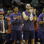 The Phoenix Suns bench celebrates the win at the close of the second half of an NBA preseason basketball game against the San Antonio Spurs, Sunday, Oct. 13, 2013, in San Antonio. Phoenix won 106-99. (AP Photo/Darren Abate)