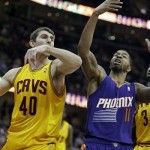 Phoenix Suns' Markieff Morris (11) battles Cleveland Cavaliers' Tyler Zeller (40) for a rebound in the third quarter of an NBA basketball game, Sunday, Jan. 26, 2014, in Cleveland. Morris scored 27 points to lead the Suns to a 99-90 win. (AP Photo/Mark Duncan)