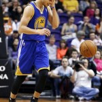  Golden State Warriors' Stephen Curry shakes his head as he dribbles the ball up the court during the first half of an NBA basketball game against the Phoenix Suns, Saturday, Feb. 8, 2014, in Phoenix. (AP Photo/Ross D. Franklin)