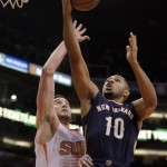 New Orleans Pelicans shooting guard Eric Gordon (10), right, drives past Phoenix Suns center Miles Plumlee (22) in the first quarter during an NBA basketball game on Sunday, Nov. 10, 2013, in Phoenix. (AP Photo/Rick Scuteri)