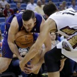 Phoenix Suns power forward Miles Plumlee battles for a loose ball with New Orleans Pelicans power forward Jason Smith (14) in the first half of an NBA basketball game in New Orleans, Tuesday, Nov. 5, 2013. (AP Photo/Gerald Herbert)